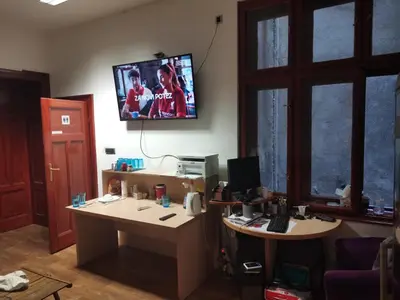 an office with a desk with a computer and a tv on the wall at Cozy place 1 in Belgrade