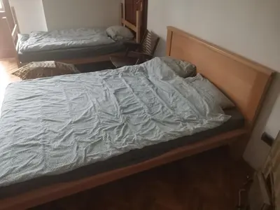 an unmade bed in a small room with at Cozy place 1 in Belgrade
