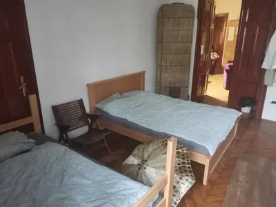 a room with two beds and a chair at Cozy place 1 in Belgrade