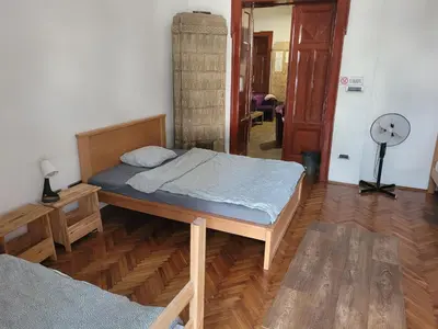 a bedroom with a bed and a fan in it at Cozy place 1 in Belgrade