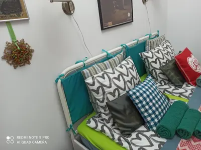 a bench with pillows on it in a room at Apartment Tesla Space in Belgrade