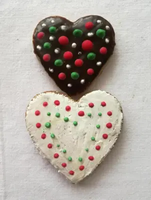 two heart shaped cookies sitting next to each other at Apartment Tesla Space in Belgrade