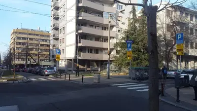 an empty city street with a tall building at Apartment Tesla Space in Belgrade