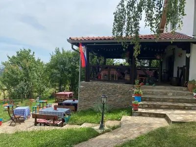 a house with a table and chairs and a patio at Bas u inat babarogama in Koraćica