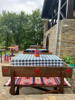 a picnic table on a bench in a patio at Bas u inat babarogama in Koraćica