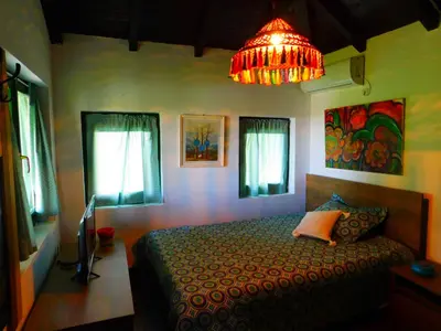 a bedroom with a bed and a chandelier at Bas u inat babarogama in Koraćica