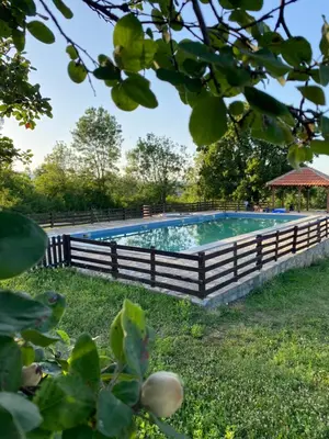 a swimming pool with a fence around it at Bas u inat babarogama in Koraćica