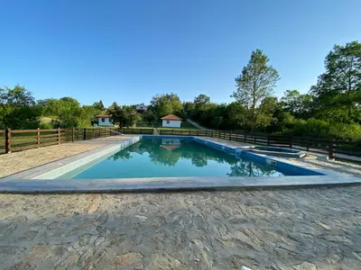 a swimming pool with a fence around it at Bas u inat babarogama in Koraćica