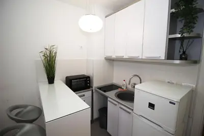 a small kitchen with white cabinets and a sink at Apartment Delta City Tata New Belgrade in Belgrade