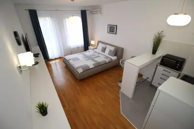 a small bedroom with a bed and a desk at Apartment Delta City Tata New Belgrade in Belgrade