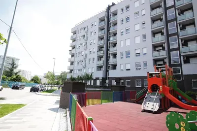 a playground in front of a apartment building at Apartment Delta City Tata New Belgrade in Belgrade