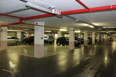 an empty parking garage with cars parked in it at Apartment Delta City Tata New Belgrade in Belgrade