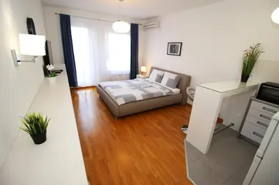 a living room with a bed and a desk at Apartment Delta City Tata New Belgrade in Belgrade