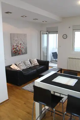a living room with a couch and a table at Vanja’s place in Dušanovac (historical)
