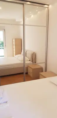a bedroom with a bed and a mirror at Vanja’s place in Dušanovac (historical)