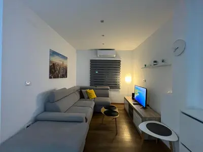 a living room with a couch and a television at Bamsae Belgrade in Vračar (historical)