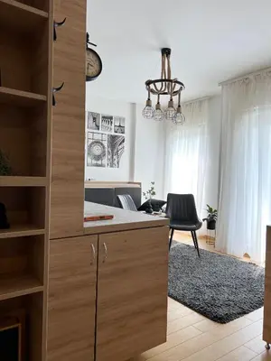 a kitchen with a large wooden cabinet and a desk at Delete 5 - Zemunske Kapije in Belgrade