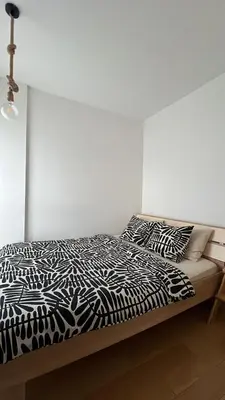 a black and white bed in a white room at Delete 5 - Zemunske Kapije in Belgrade