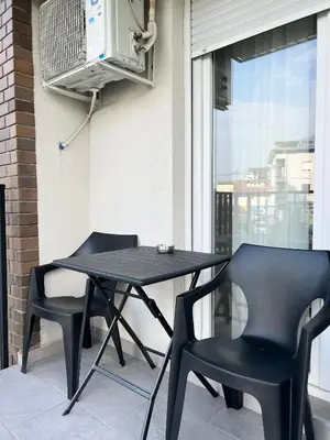 a black table and two chairs on a balcony at Delete 5 - Zemunske Kapije in Belgrade