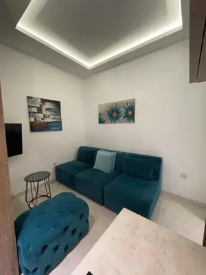 a living room with a blue couch and a table at Belgrade Nest D&A in Belgrade