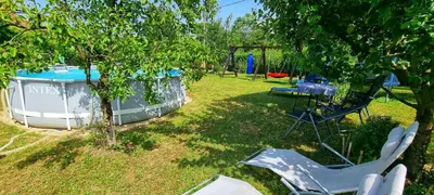 a yard with a boat and a table and chairs at Gajica konak-Orasac in Arandjelovac