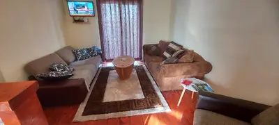 a living room with two couches and a tv at Gajica konak-Orasac in Arandjelovac