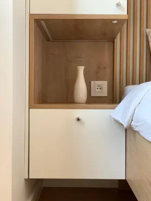 a white vase sitting on top of a white dresser at Selena apartment in Belgrade