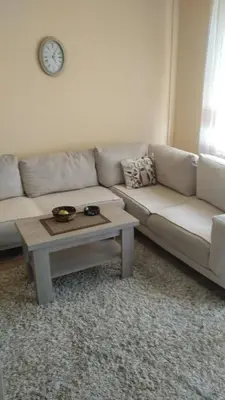 a living room with a couch and a coffee table at Relax 2 besplatan parking in Obrenovac