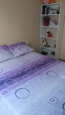 a purple bed with a purple and white bedspread at Relax 2 besplatan parking in Obrenovac