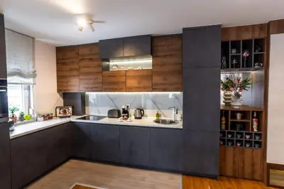 a kitchen with wooden cabinets and a counter top at Apartman AuRa in Arandjelovac