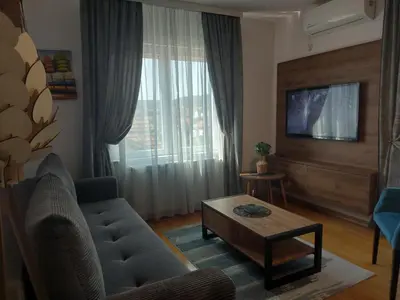 a living room with a couch and a coffee table at Apartman AuRa in Arandjelovac
