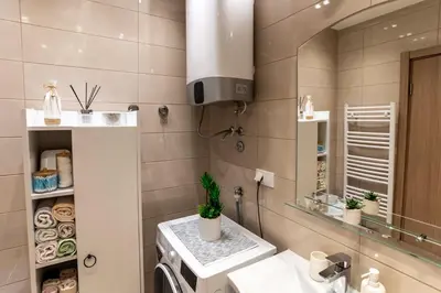 a bathroom with a sink and a mirror at Apartman AuRa in Arandjelovac
