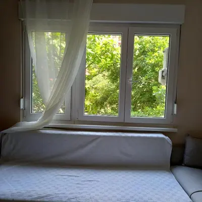 a window with a bed in front of it at Rivijera in Belgrade