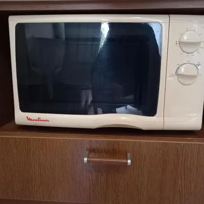 a white microwave sitting on top of a wooden cabinet at Rivijera in Belgrade