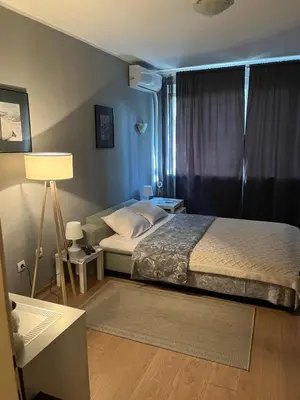 a bedroom with a bed and a lamp in it at Grey in Belgrade