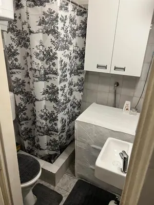 a small bathroom with a toilet and a sink at Grey in Belgrade