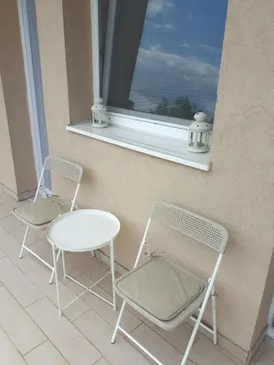 two chairs and a table in front of a window at River Casa in Ledine