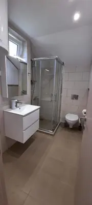 a bathroom with a shower and a sink and a toilet at River Casa in Ledine