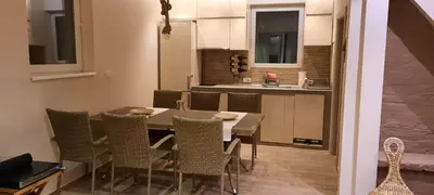 a kitchen and dining room with a table and chairs at River Casa in Ledine