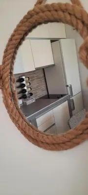 a mirror with a reflection of a refrigerator at River Casa in Ledine