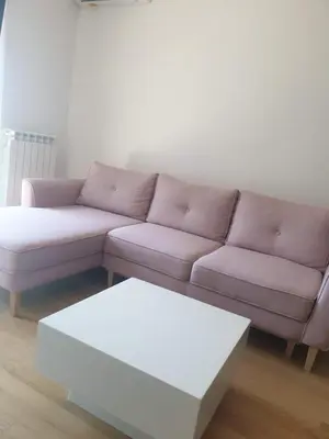 a living room with a purple couch and a white table at Minel cosy apartment in Belgrade