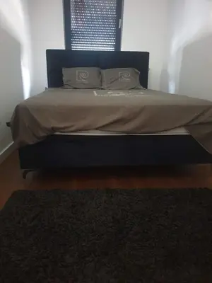 a bed with two pillows on it in a bedroom at Minel cosy apartment in Belgrade