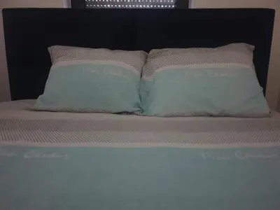 two pillows sitting on top of a bed at Minel cosy apartment in Belgrade
