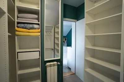 a walk in closet with a door and shelves at Family / Coworking Retreat Belgrade in Belgrade