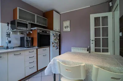 a kitchen with a table with chairs and a refrigerator at Family / Coworking Retreat Belgrade in Belgrade