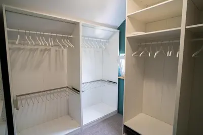 a walk in closet with white doors and shelves at Family / Coworking Retreat Belgrade in Belgrade