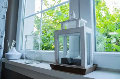 a lantern sitting on a window sill in front of a window at Family / Coworking Retreat Belgrade in Belgrade
