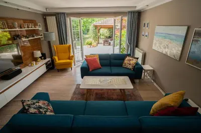 a living room with a blue couch and a table at Family / Coworking Retreat Belgrade in Belgrade