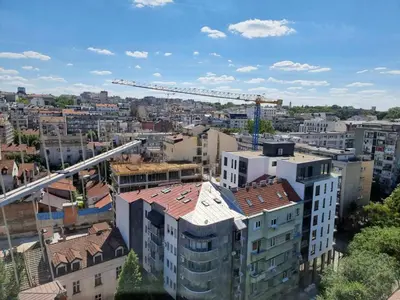 an overhead view of a city with a crane at Sunset in Belgrade