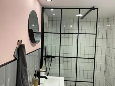 a bathroom with a shower and a sink and a mirror at Loup 1981 in Bežanija